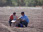 Hydrologists monitor data collection during a geophysical survey 